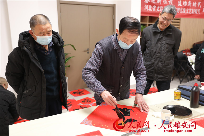 圖為容西片區(qū)愛(ài)水社區(qū)組織寫福字、春聯(lián)。人民網(wǎng) 楊華龍攝