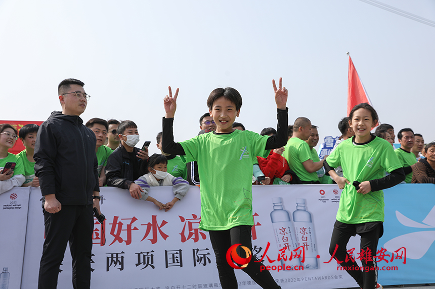 2023雄安半程馬拉松現(xiàn)場，完成健康跑的小選手正在慶祝勝利。人民網(wǎng) 李兆民攝